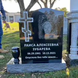photo of upright headstone black marble grave marker with porcelain photo inlays and Mother Mary statue at Lone Tree Cemetery in Hayward, California with cemetery and monument vases
